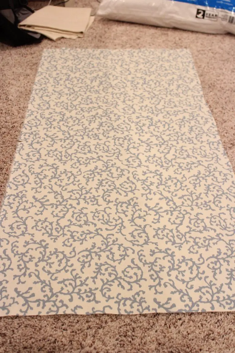 Blue patterned fabric cut to size before sewing into a cushion cover.