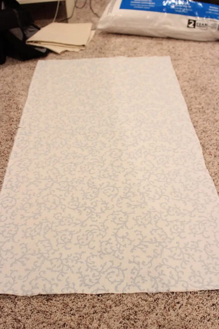 Measured fabric rectangle laid out for sewing a simple cushion cover.