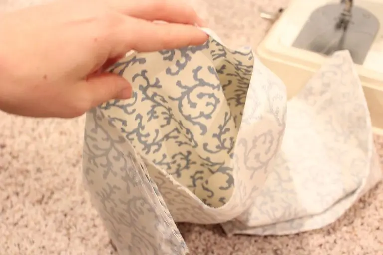 Blue and white patterned fabric pillow cover opened wide, prepared for filling.