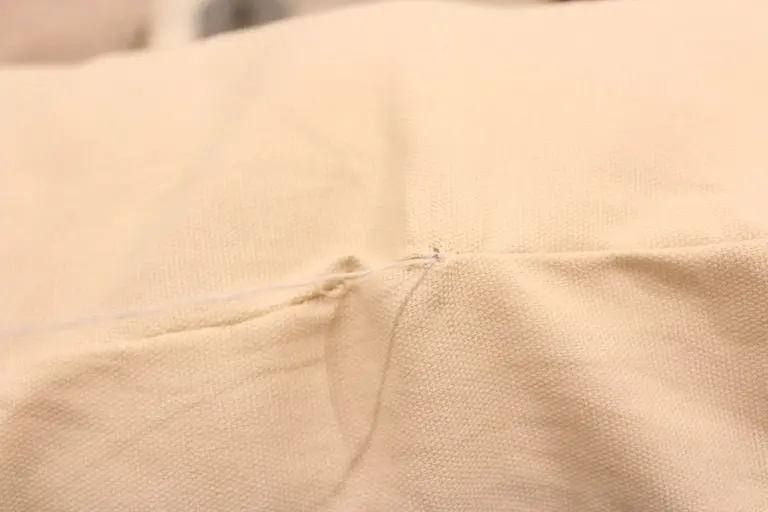 Alternating stitches forming a ladder pattern on a pillow opening.