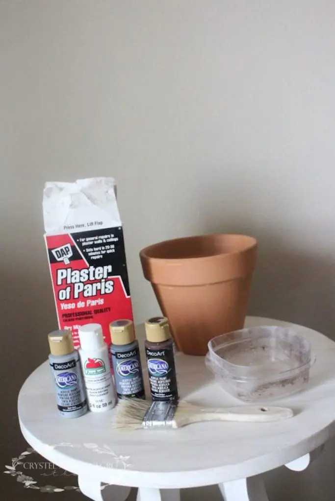 Plaster of Paris next to a terra cotta pot and paint
