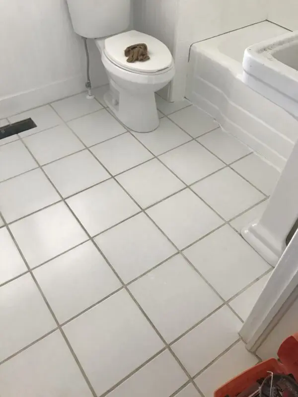 Clean white tile floor in bathroom
