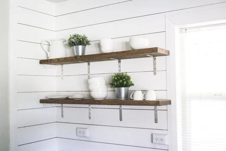 Stained shelf with brackets on shiplap