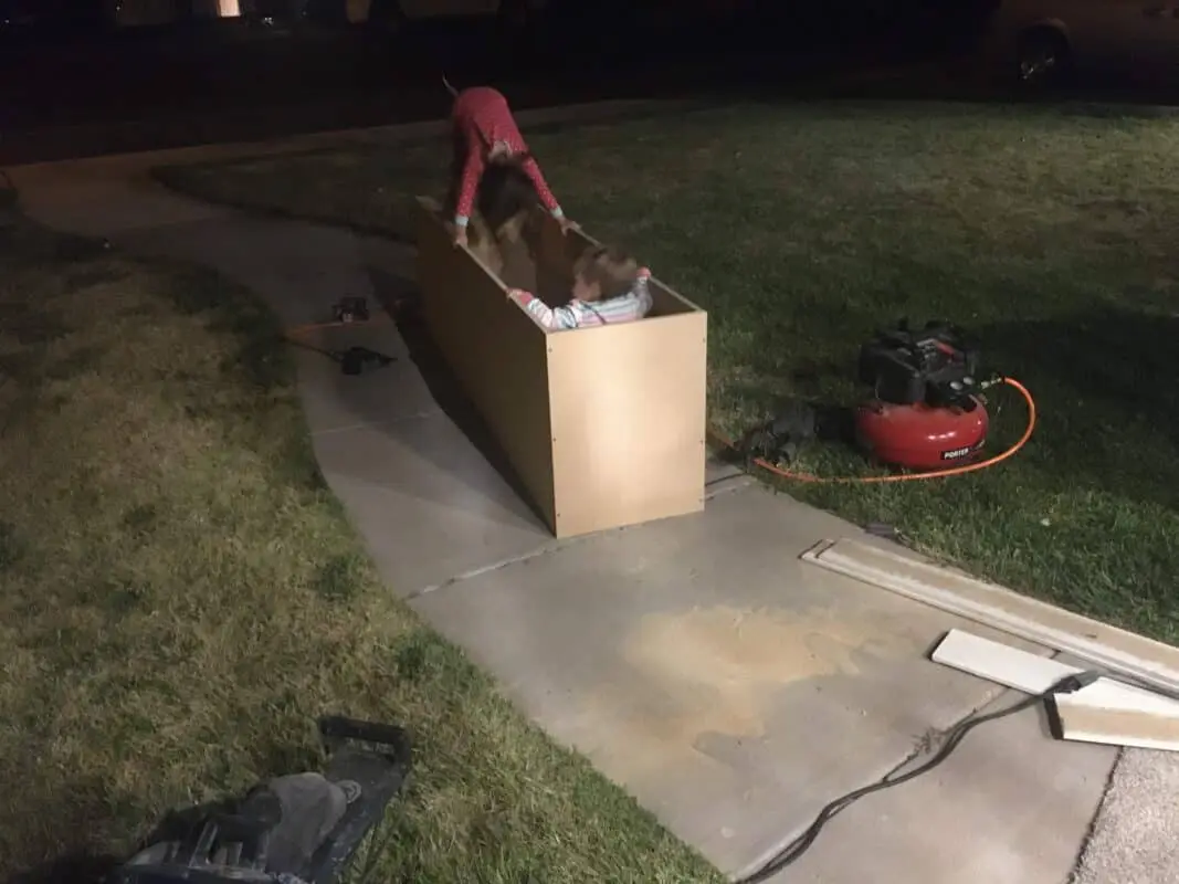 two girls playing in a box