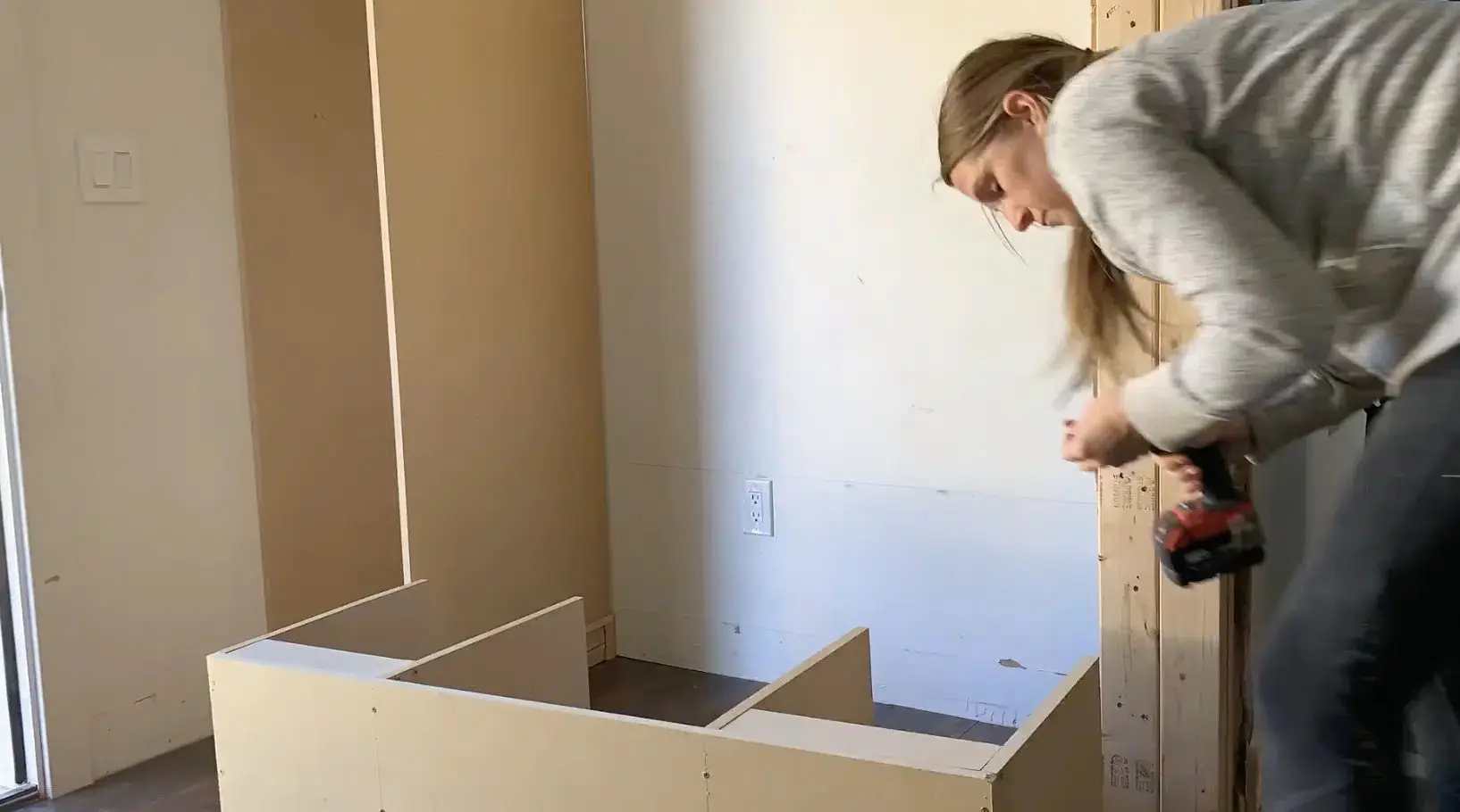 woman using a nail gun on mdf