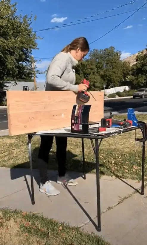 Woman screwing wood together