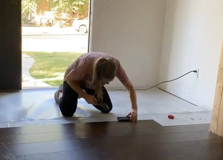 woman installing wood floor
