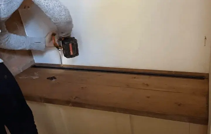 Woman screwing wood together
