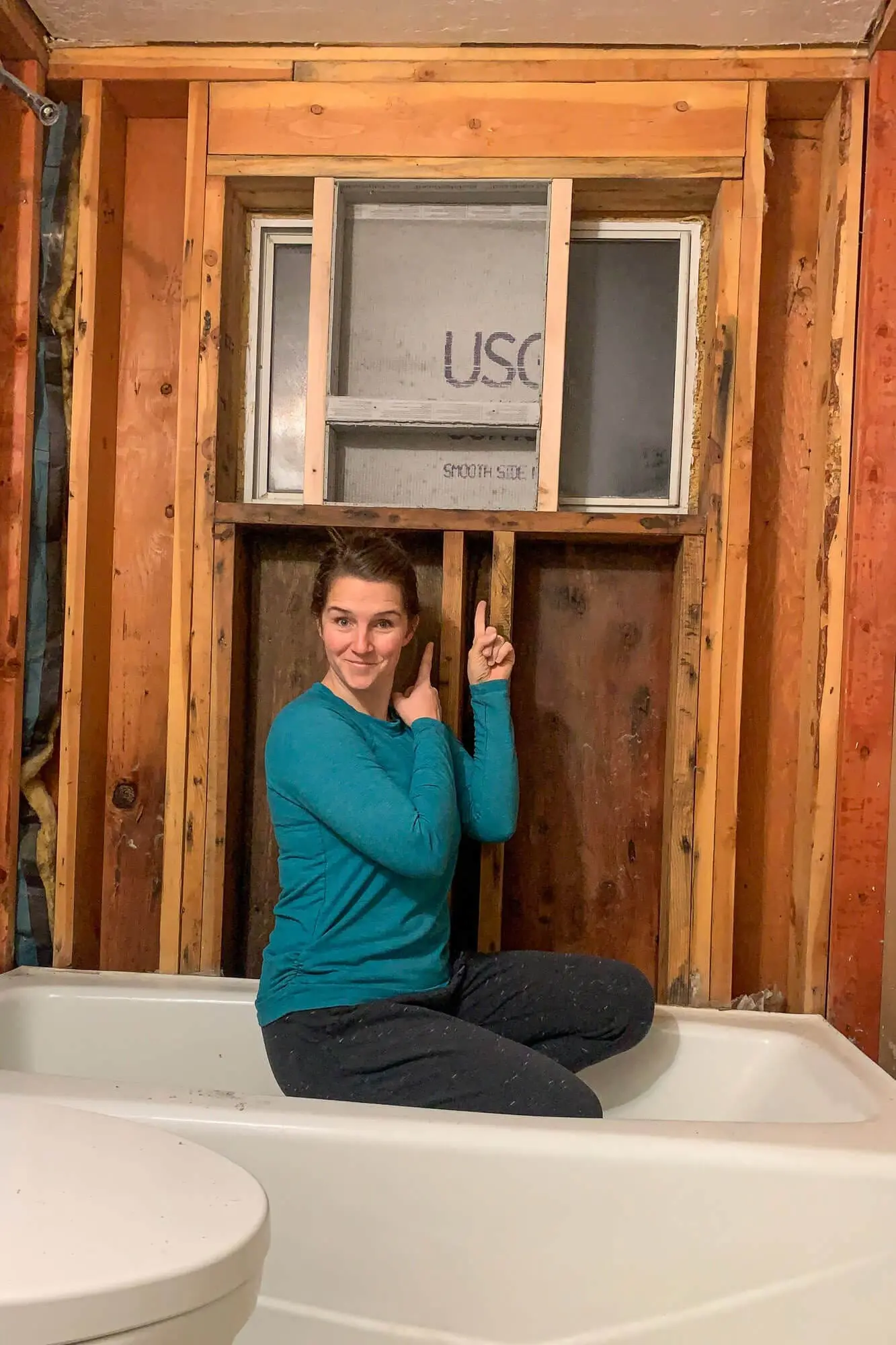 Shower niche framed between studs with pitched bottom shelf.