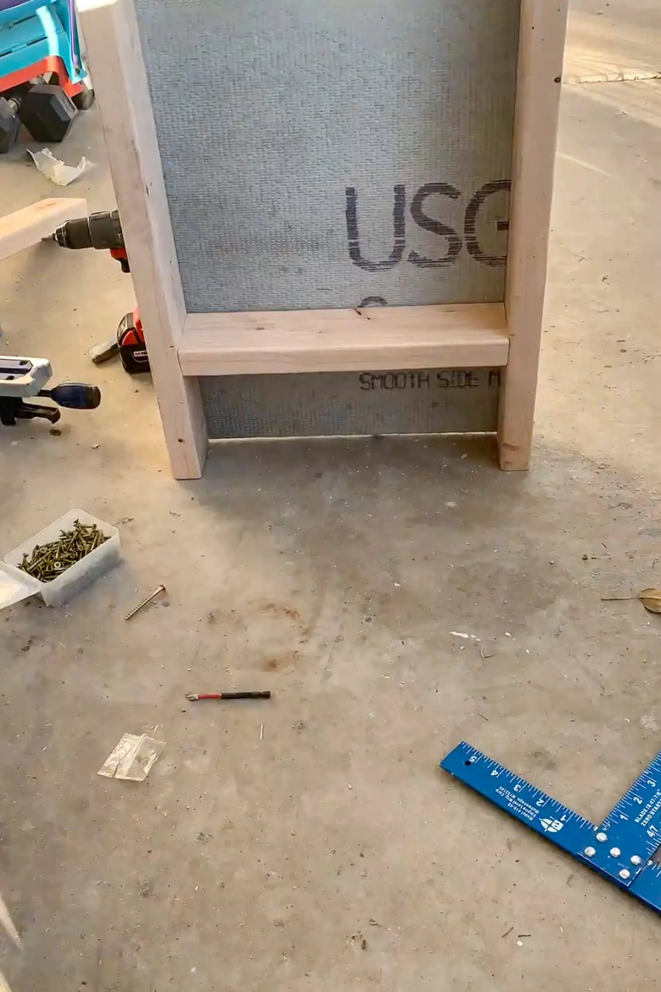 DIY shower niche frame with cement board on workbench during shower mold removal—how to remove shower mold and prep walls for tile.