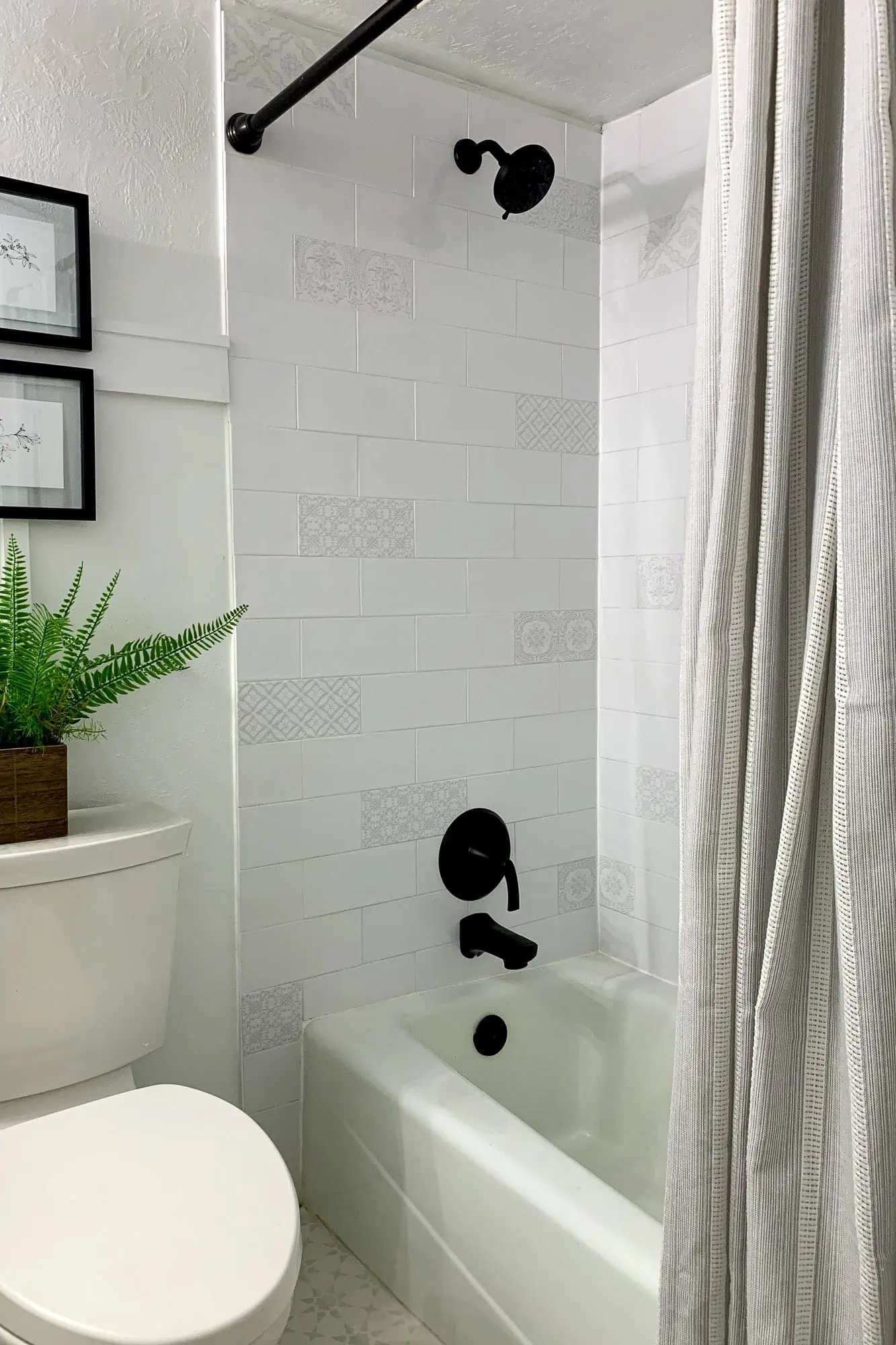 Small bathroom remodel after photo showing vanity, toilet, and tub.