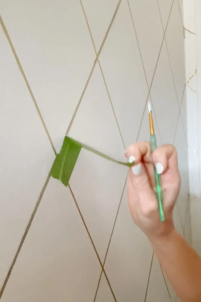 Woman painting bathroom wall white