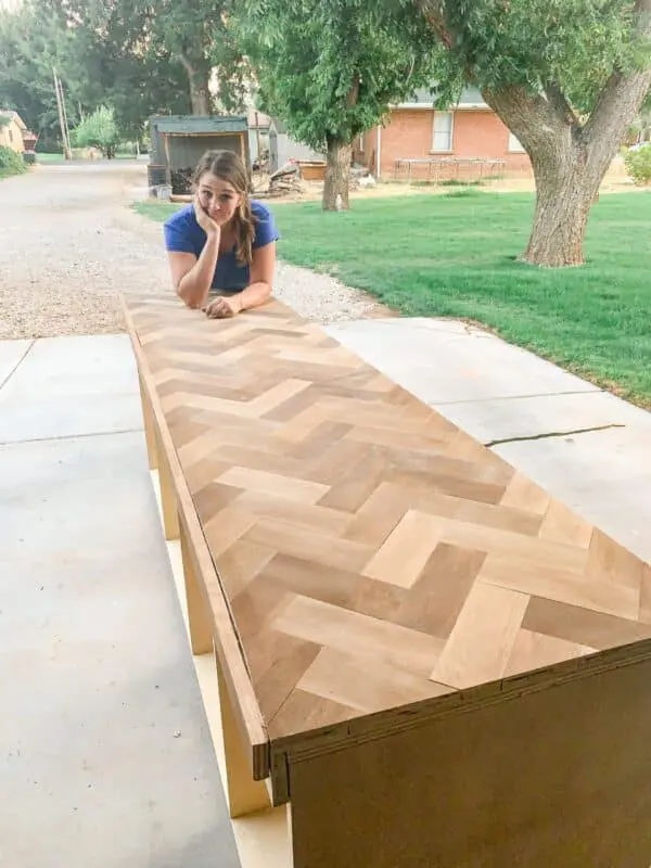 woman leaning on herringbone countertop