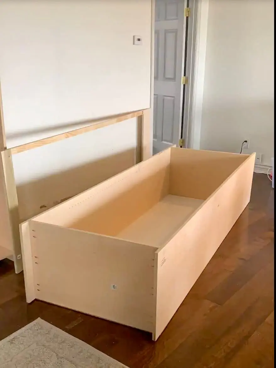 adjustable shelves being installed, creating a customizable home office storage solution.