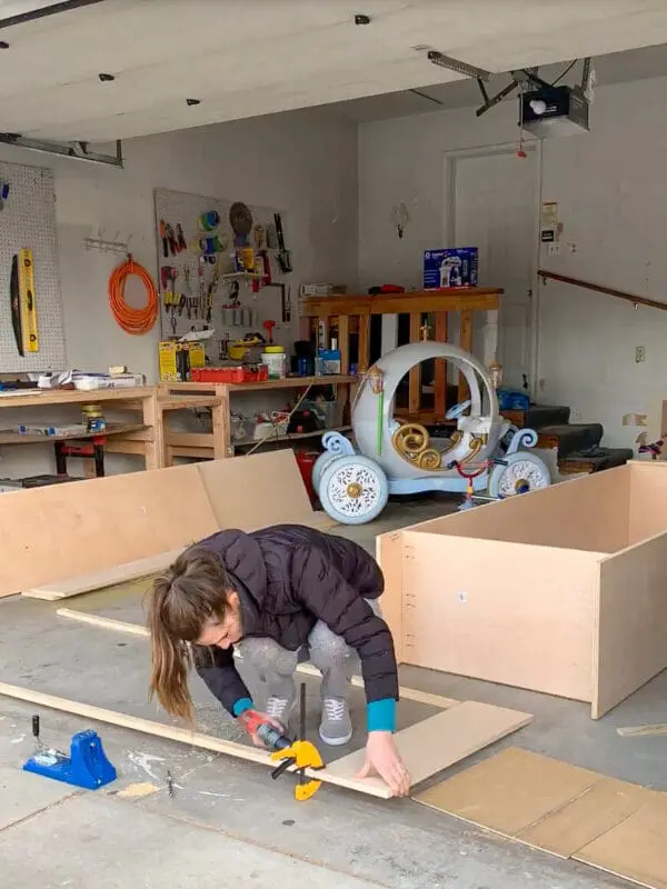 DIYer assembling office cabinet boxes using pocket hole screws for a sturdy and professional built-in home office setup.