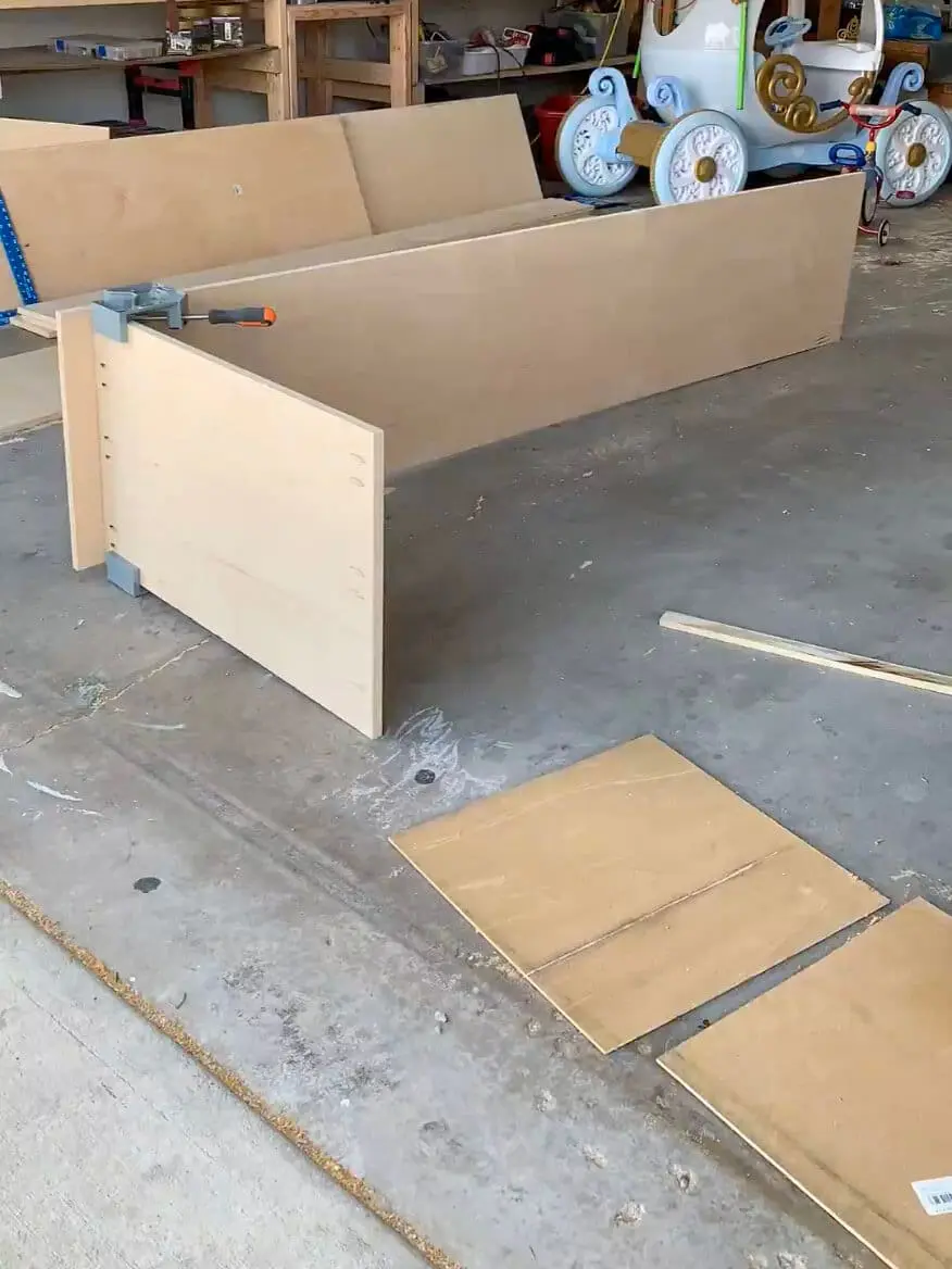 DIY home office cabinet build in progress, featuring assembled plywood cabinet boxes ready for installation.