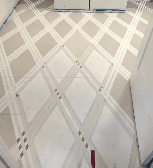 Painted laundry room flor using tape as a stencil