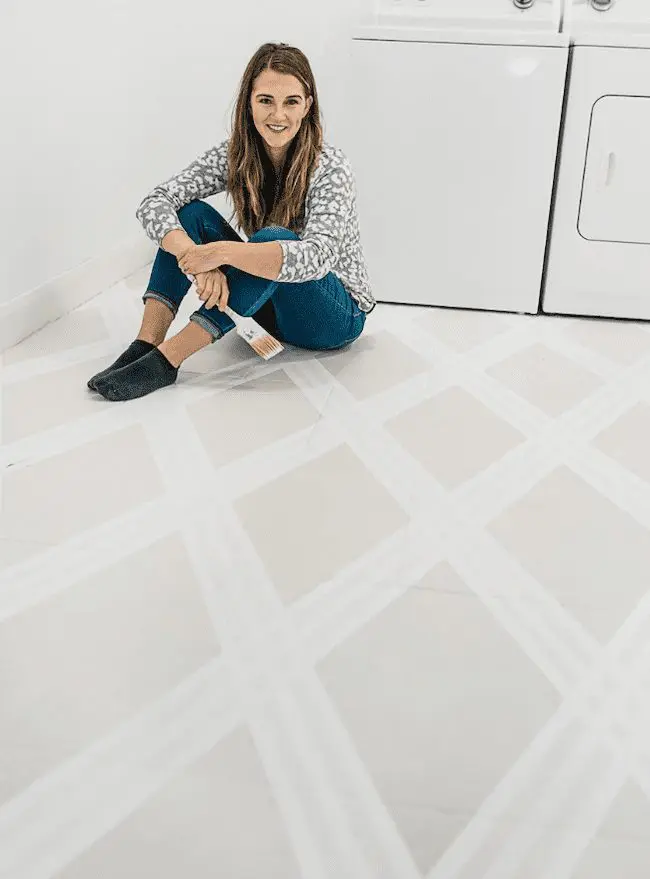 Woman sitting on painted tile floor