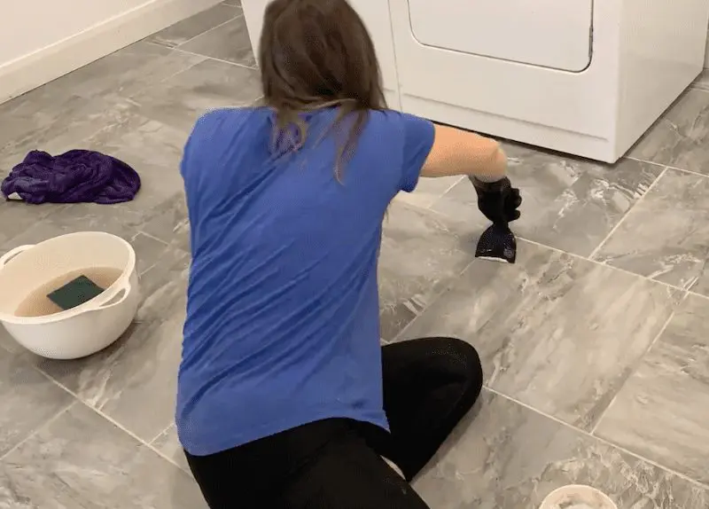 Finger pointing to grey tile