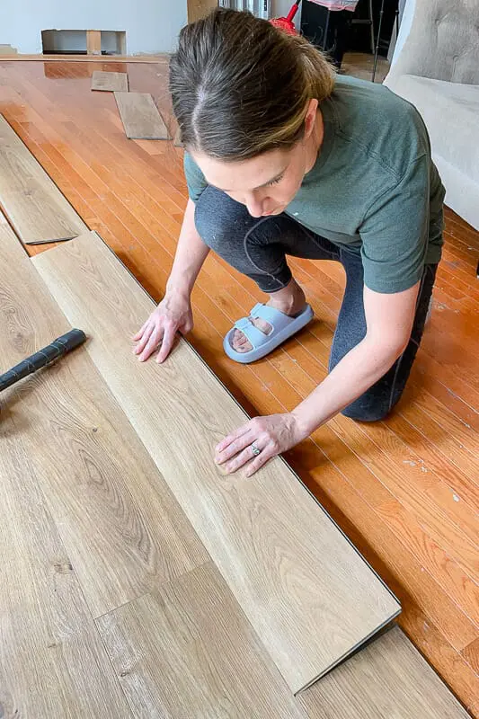Woman installing hardwood