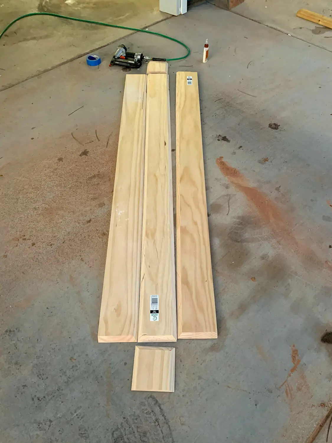 Three pine boards with mitered edges laid flat ready for miter fold assembly