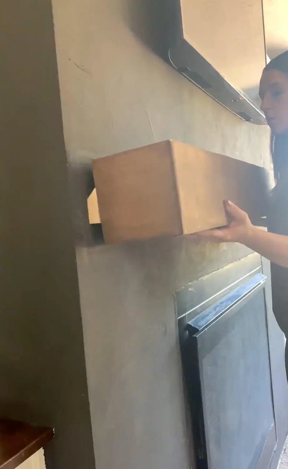 French cleat piece being held showing how 45-degree angle hooks onto wall cleat