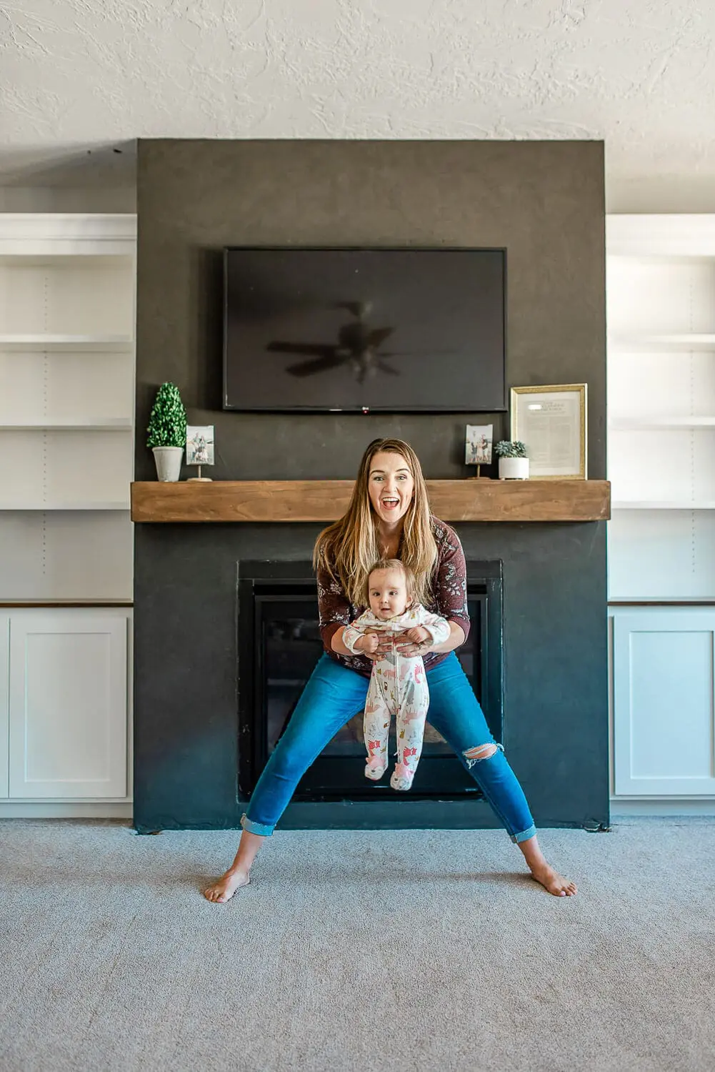 Living room showing black fireplace surround with stained floating mantel installed