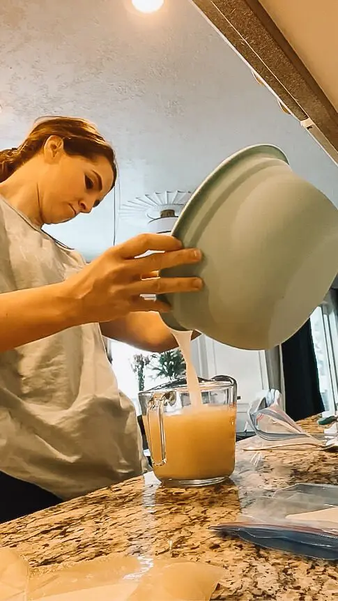 woman measuring bone broth