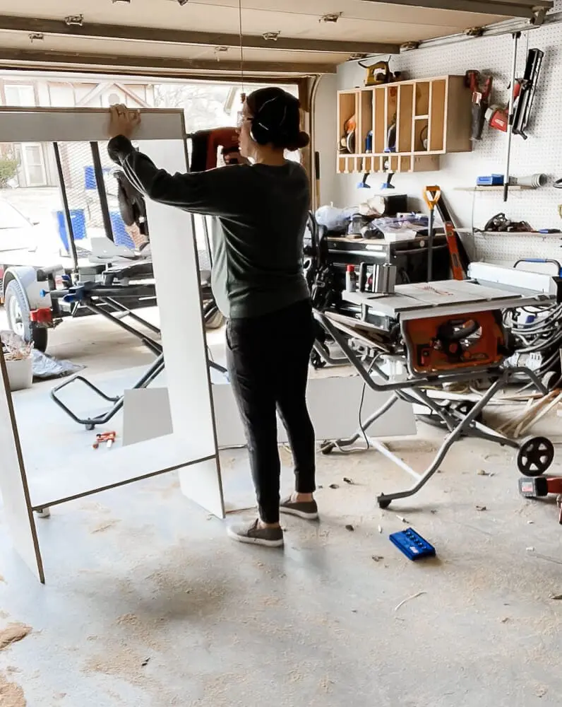 woman constructing cabinet for a built in