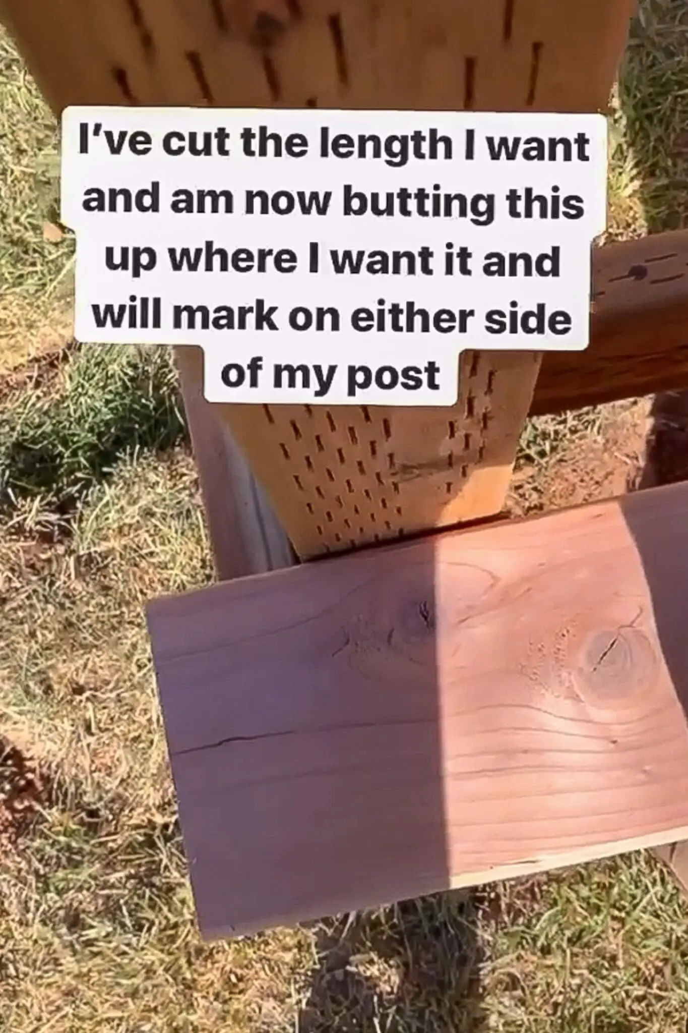 Wood board being measured and marked around a vertical post as part of the trim installation for a DIY small front porch project.