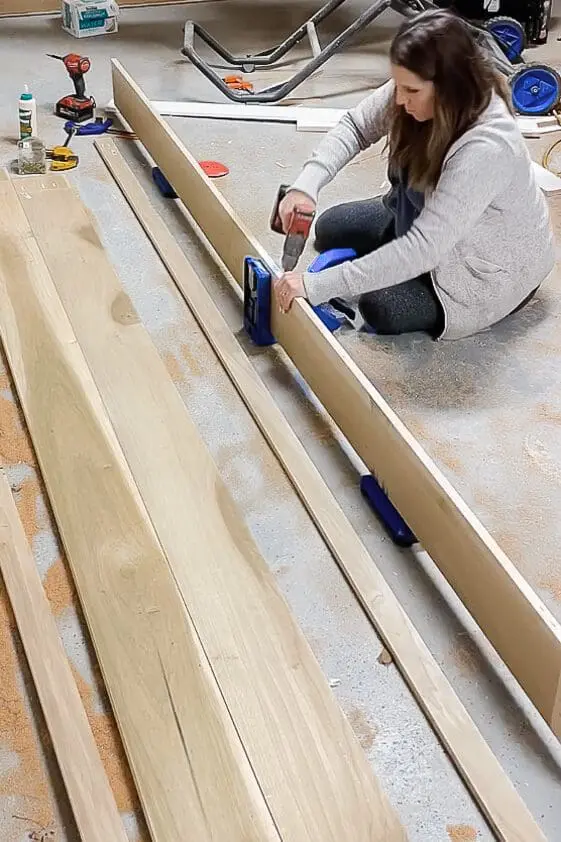 woman drilling pocket holes into poplar