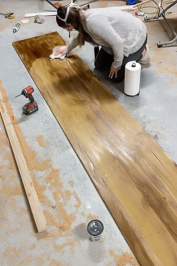 Woman staining a desk