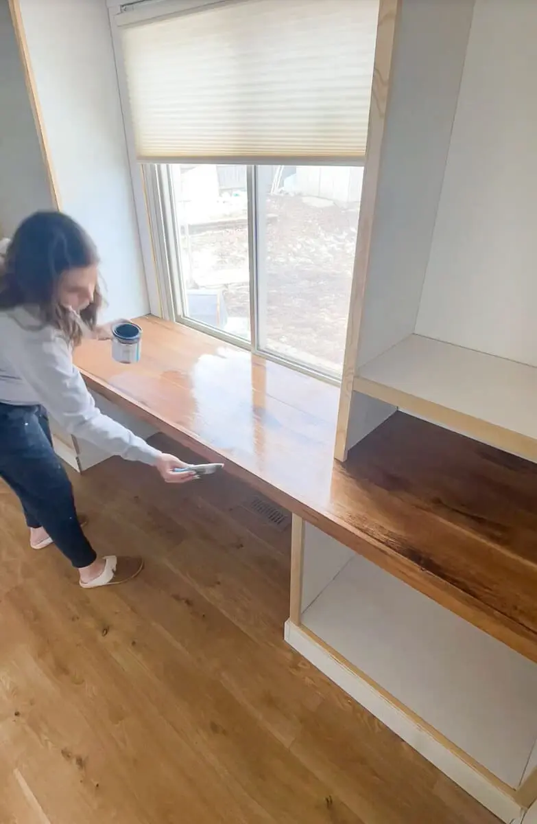 Woman sealing a desk top