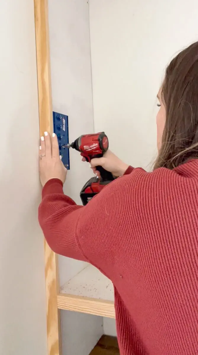 Woman installing adjustable shelves