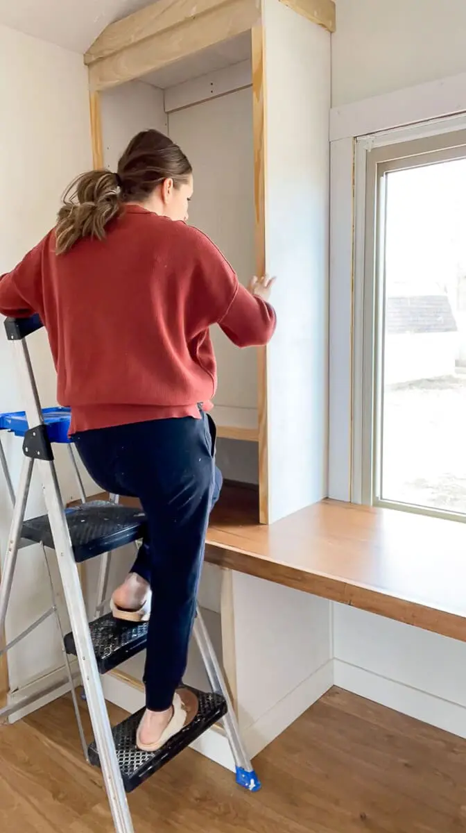 Woman filling in nail holes