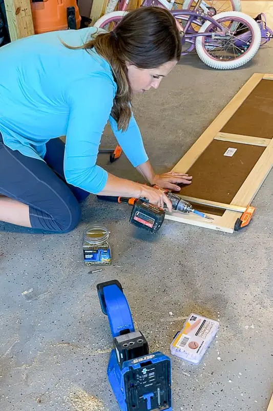 woman drilling pocket holes on. a shaker door