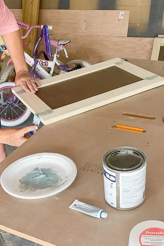 applying bondo on a shaker door