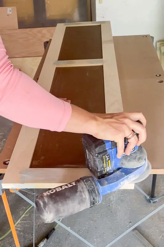 woman sanding shaker style door