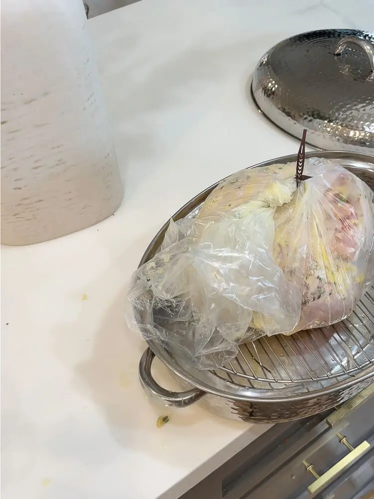A turkey prepped in a roasting bag, ready to be baked for super moist and tender results.