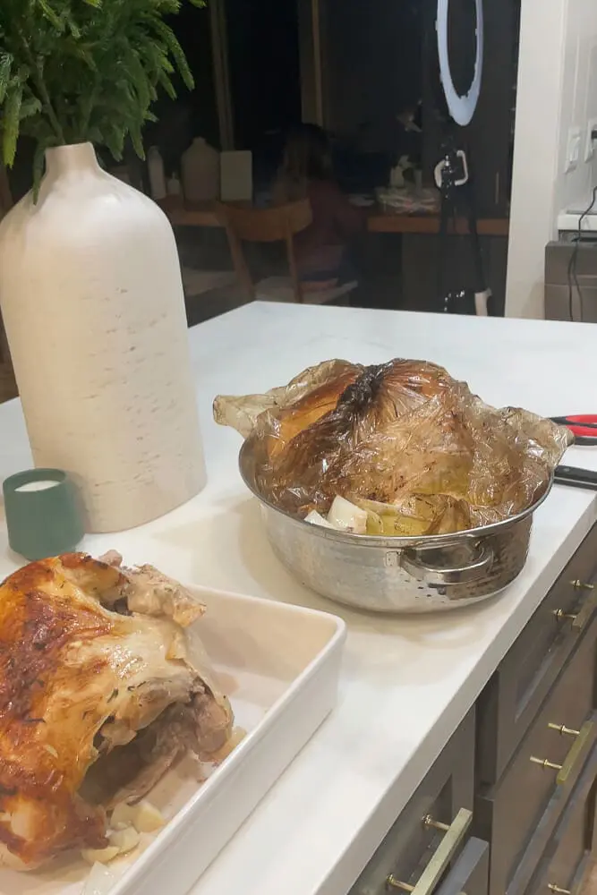 Roasted turkey resting in a roasting bag after baking, the meat super moist and tender.