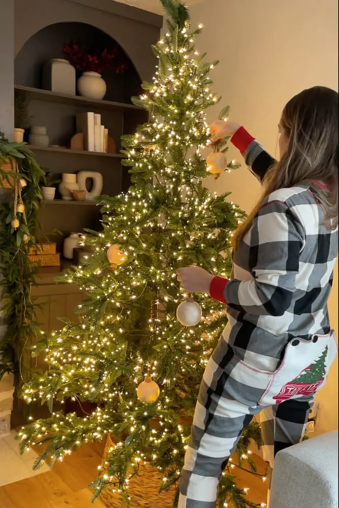lady decorating an old-fashioned christmas tree