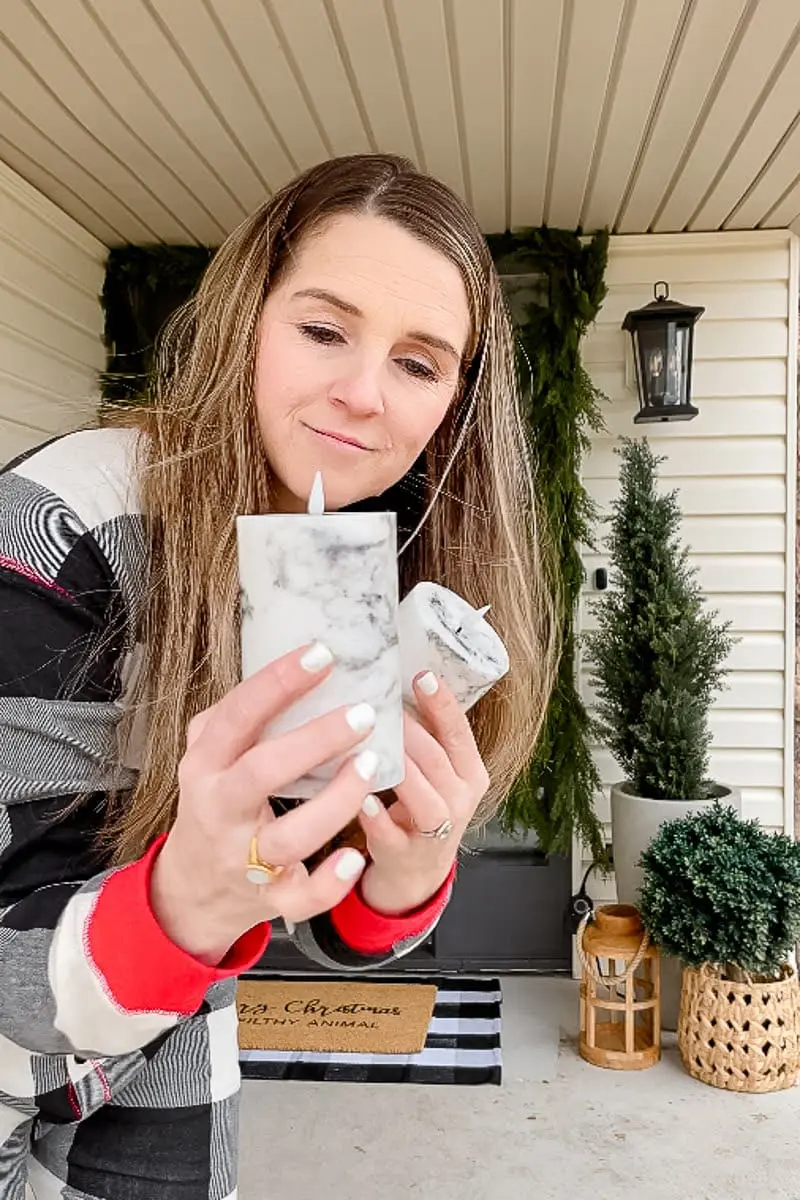 Woman holding battery-operated decorative marble candles