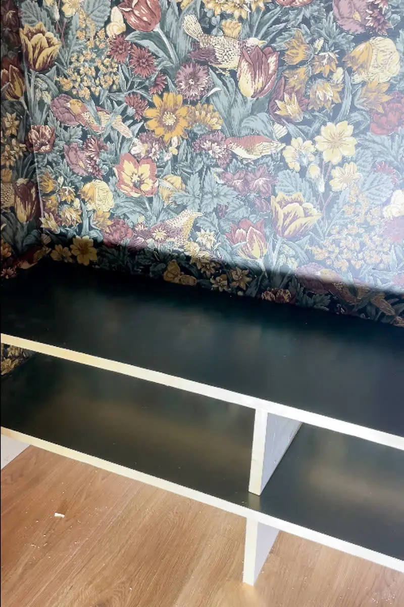 Finished green custom shoe shelves in coat closet makeover