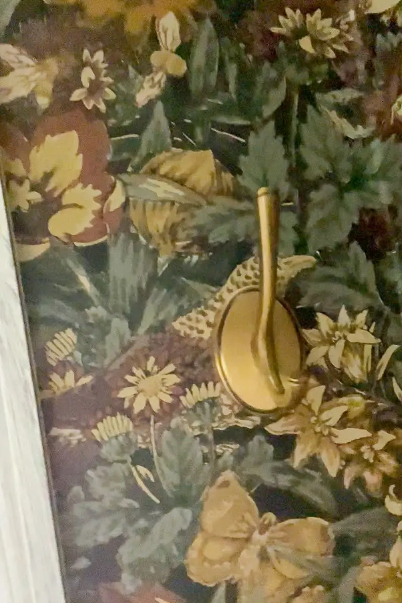 Gold hooks placed inside coat closet for coats