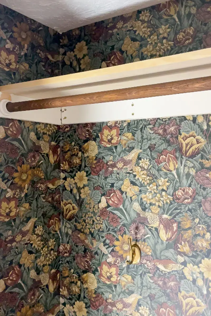 Top shelf and clothes hanging rod inside coat closet makeover