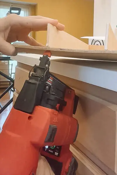 A DIY wooden drawer divider placed inside a kitchen drawer for better organization.