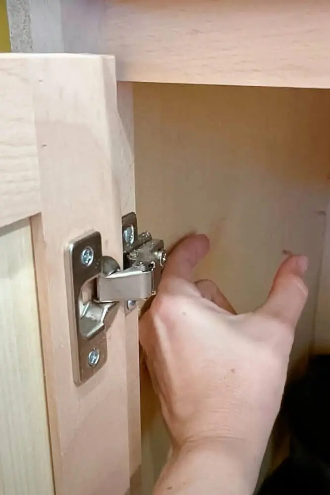 Measuring the gap inside a kitchen cabinet to determine the necessary bump-out