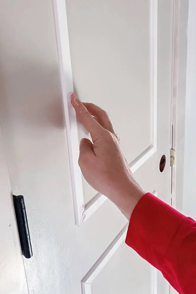 spackling holes and seams on door trim for diy closet door makeover