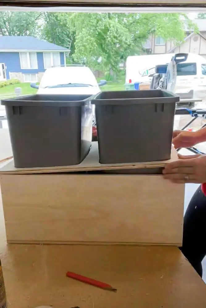 trash bin fitting snuggly inside wood drawer made for trash cabinet