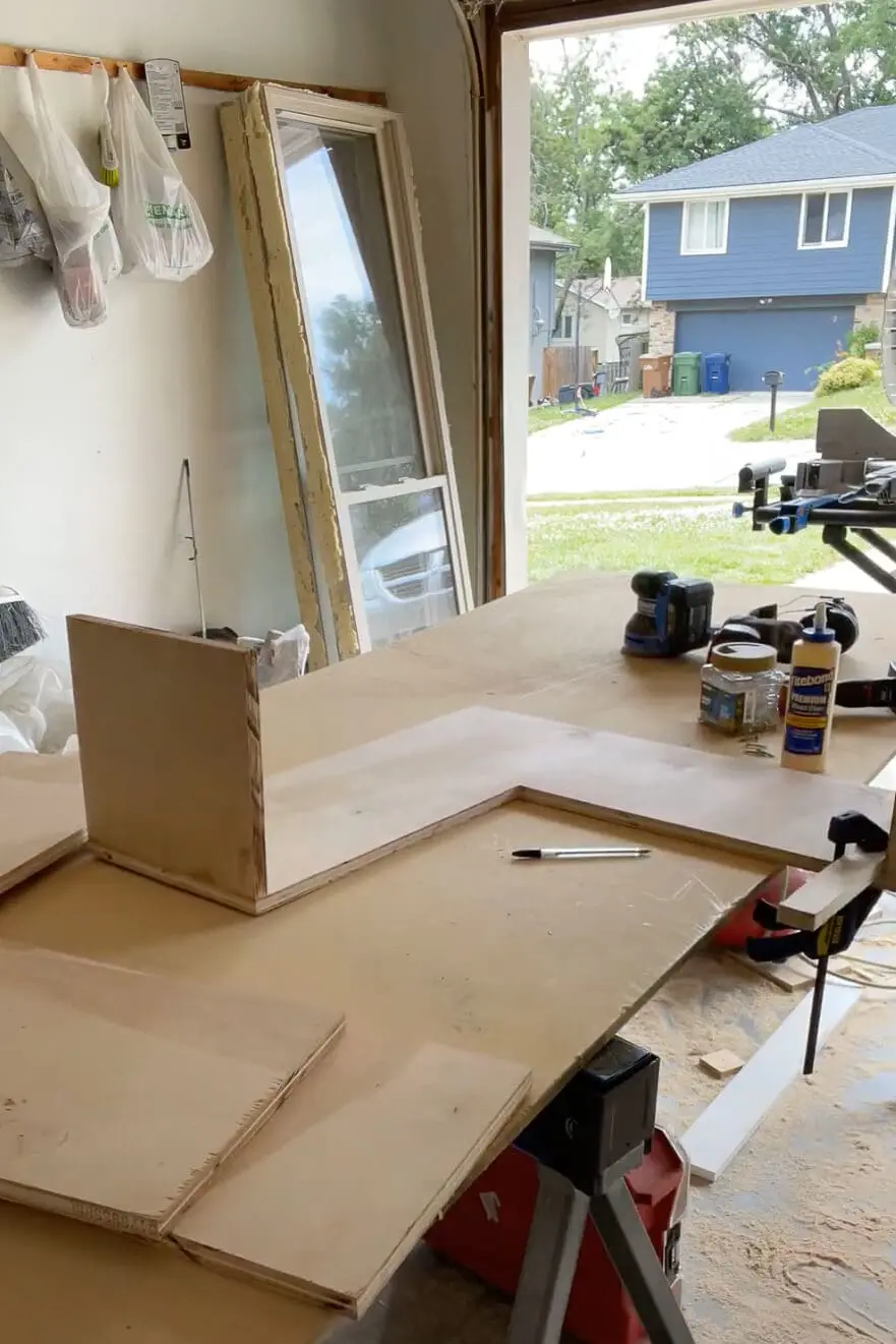 Woman assembling a cabinet box. 